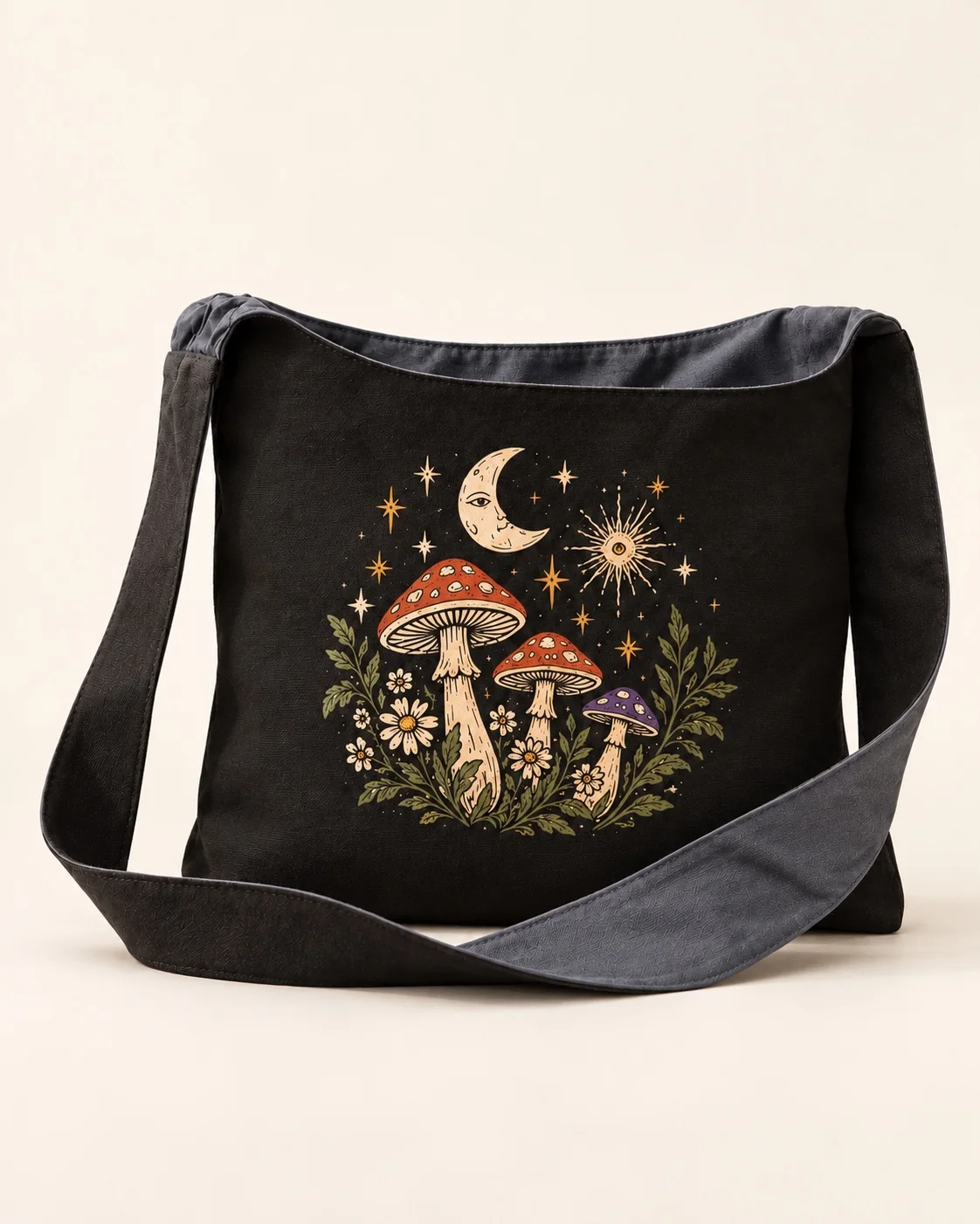 A black canvas sling bag with charcoal strap, printed with mushrooms, moon and stars